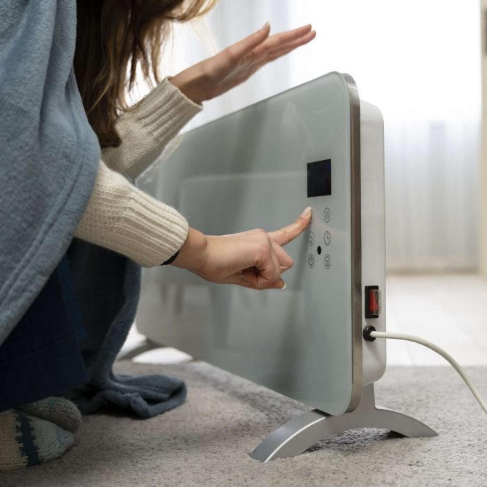 woman-sitting-near-heater-home